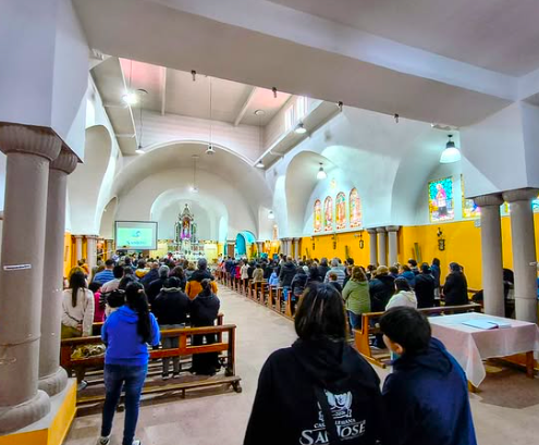 Comunidad Educativo-Pastoral y familias participando de la Fiesta de Don Bosco durante el centenario del colegio